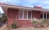 Simple but charming brick cottage of roses