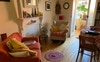 Living room opens onto sunroom and modern kitchen