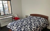 Queen room with built in robe, dresser, desk.