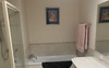 Bathroom that comes with room, has a skylight too.