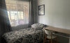Single room with king single bed, desk, storage 