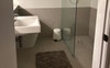 Private ensuite with large shower and cabinets. 