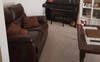 Front lounge room with piano and drum set 