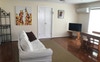 Lounge room with smart TV. Dining table.