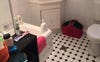 Large bathroom with laundry and shower over bath