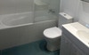 En-suite with bathtub and window
