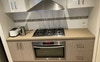 Clean and fully furnished kitchen with cabinets